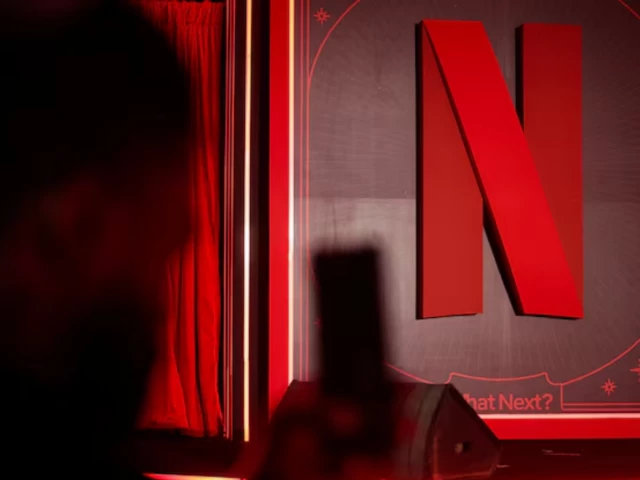a man takes a photograph next to a netflix logo during an event in mumbai india february 3 2026 photo reuters