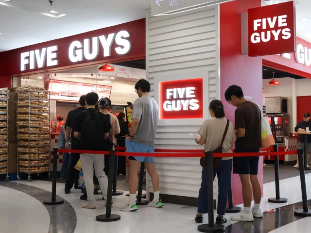 people queue at a five guys fast food restaurant after the us burger chain opened its first two locations earlier this month in beijing china august 15 2026 photo reuters